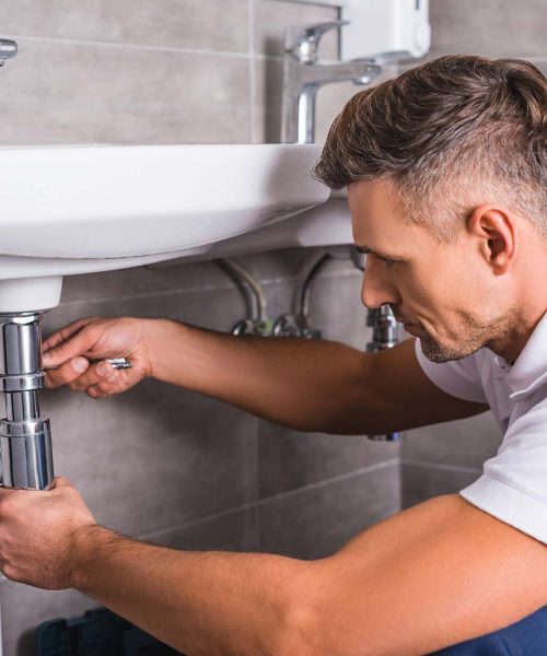 adult-plumber-fixing-sink-at-bathroom-resize.jpg