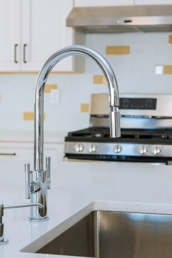 Modern domestic kitchen cabinets with new appliances and sink in kitchen