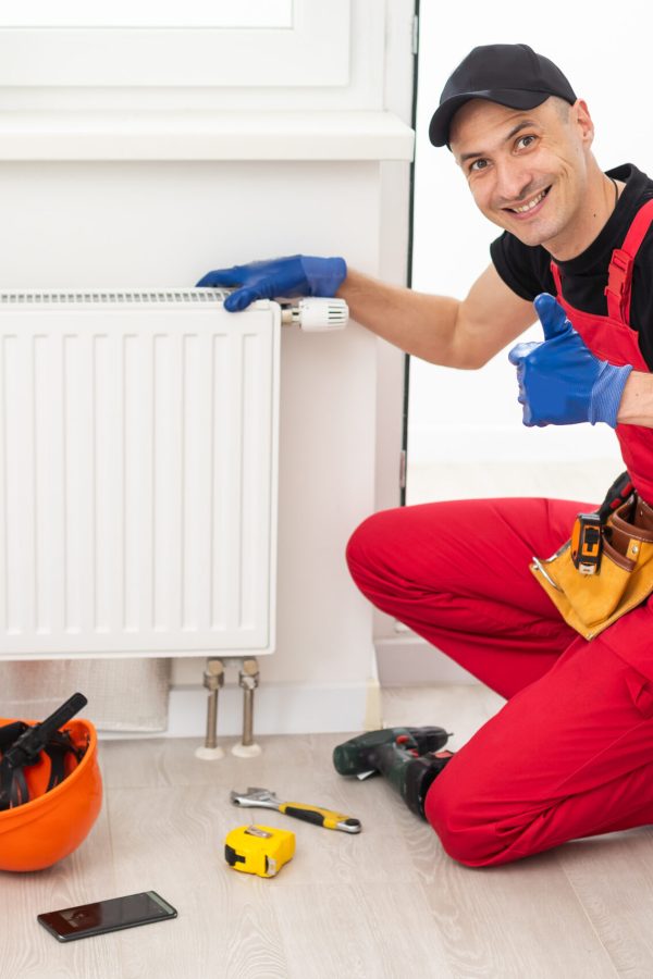 plumber at work. Installing water heating radiator. High quality photo