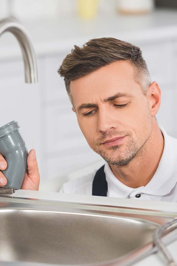 thoughtful-adult-repairman-holding-pipes-and-tools-resize.jpg